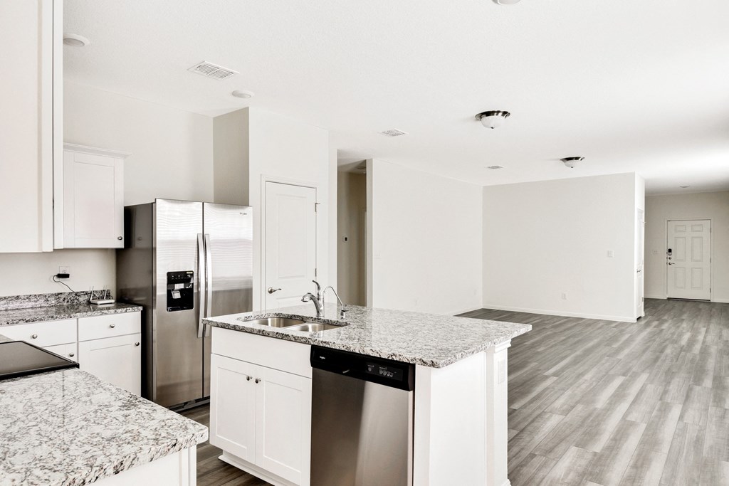 a modern kitchen with white cabinets and staiinless furnitures