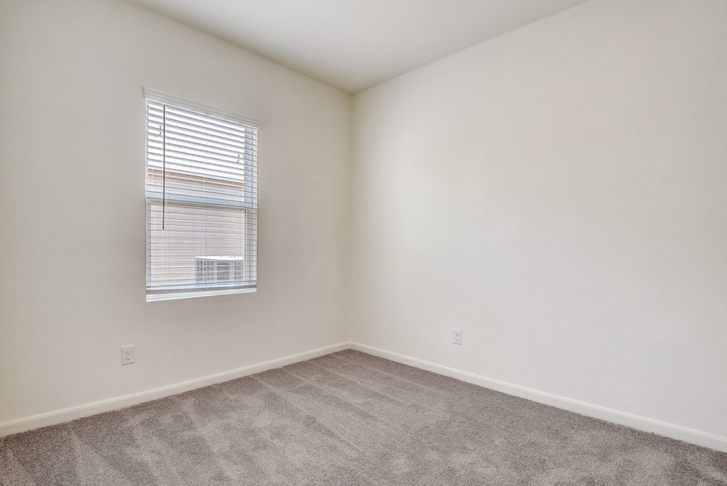 a bedroom with white walls and carpet at Beacon at Meridian, Texas