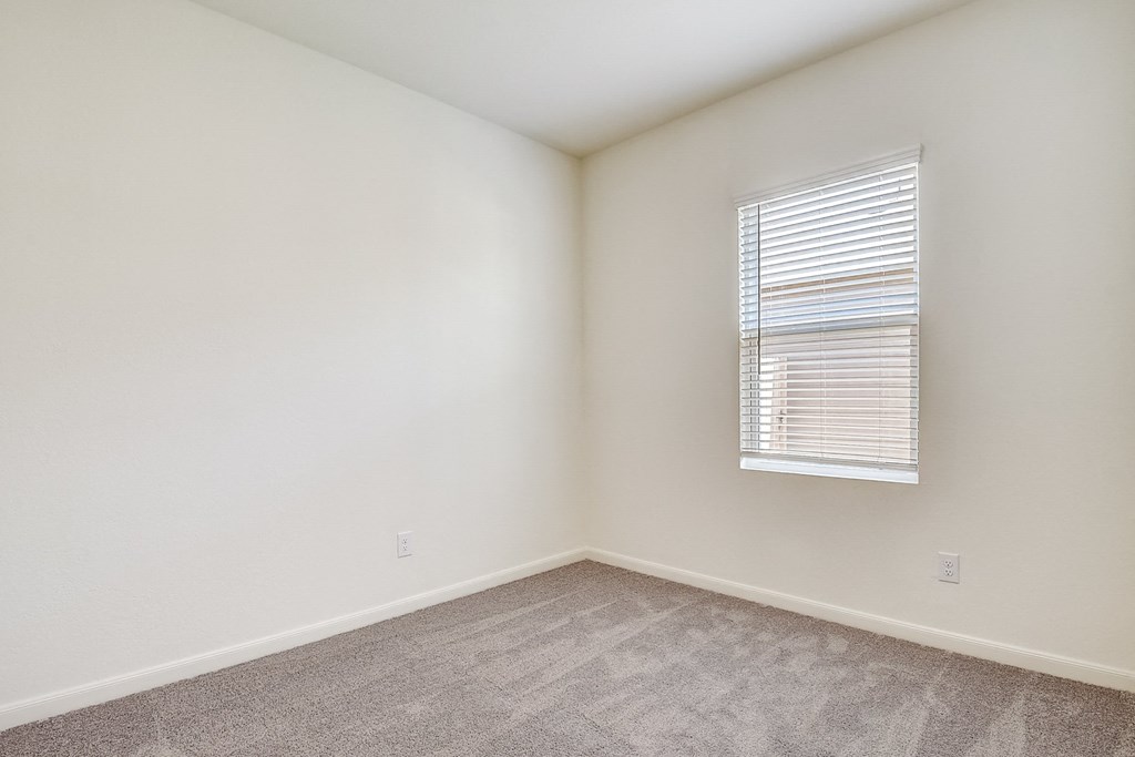 a bedroom with white walls and carpet at Beacon at Meridian, San Antonio