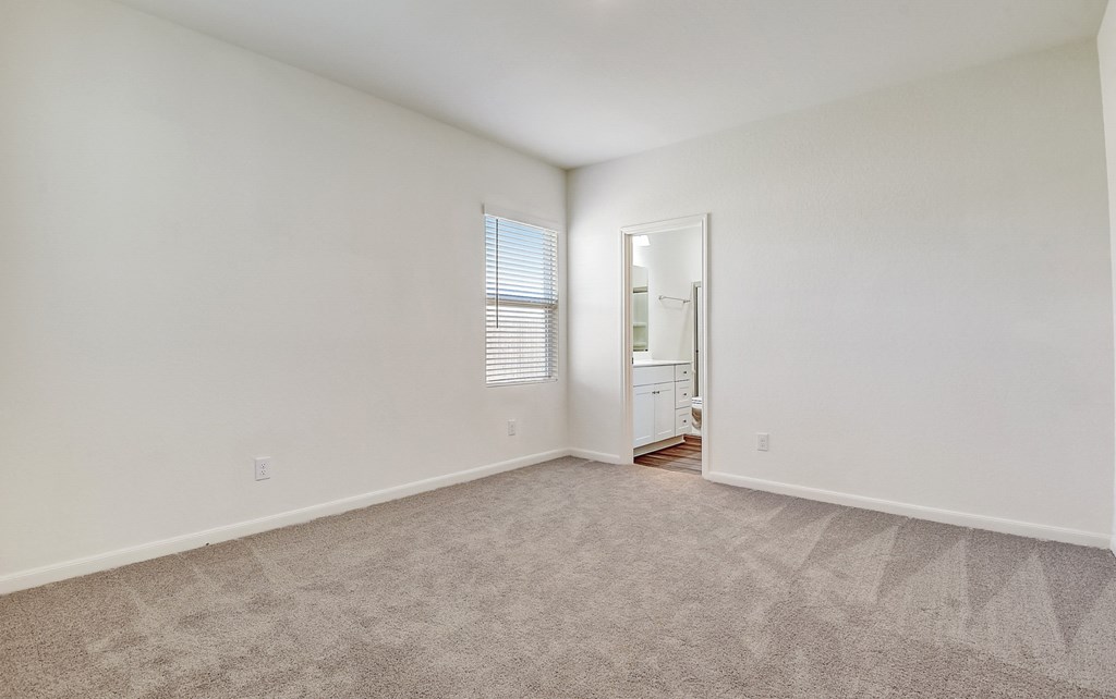 a bedroom with white walls and carpet at Beacon at Meridian, San Antonio Texas