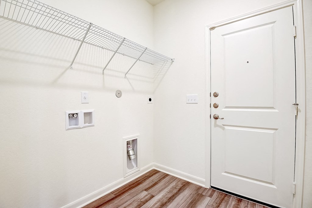 a bedroom with a wardrobe and a door to a closet at Beacon at Meridian, San Antonio, TX 78245