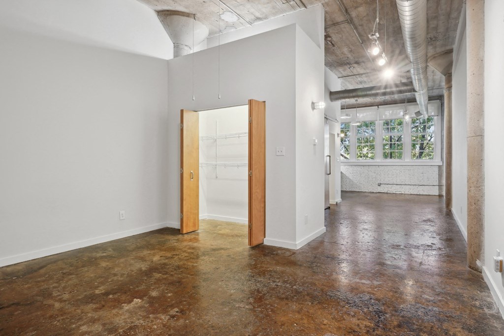 Futura Lofts entry into apartment with polished concrete floors and large closet | Deep Ellum Lofts in Dallas, TX