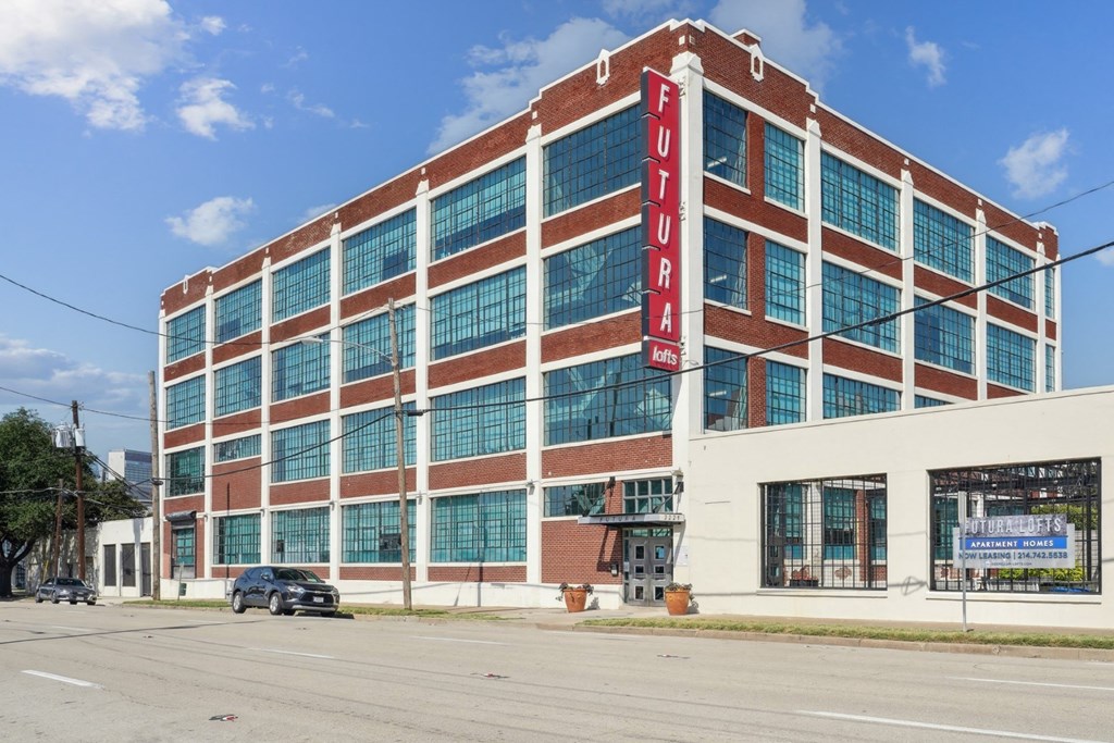 a large brick building with a red sign on the side of it