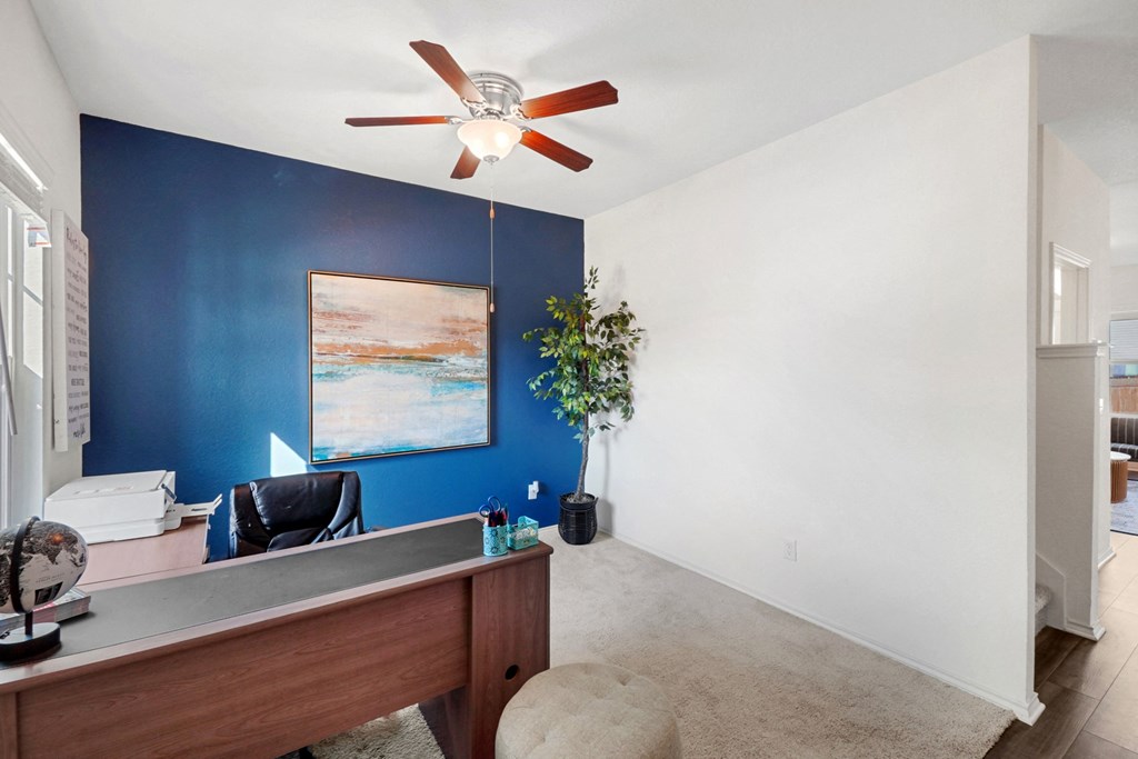 an office with a blue accent wall and a ceiling fan at Beacon at Meridian, San Antonio, TX