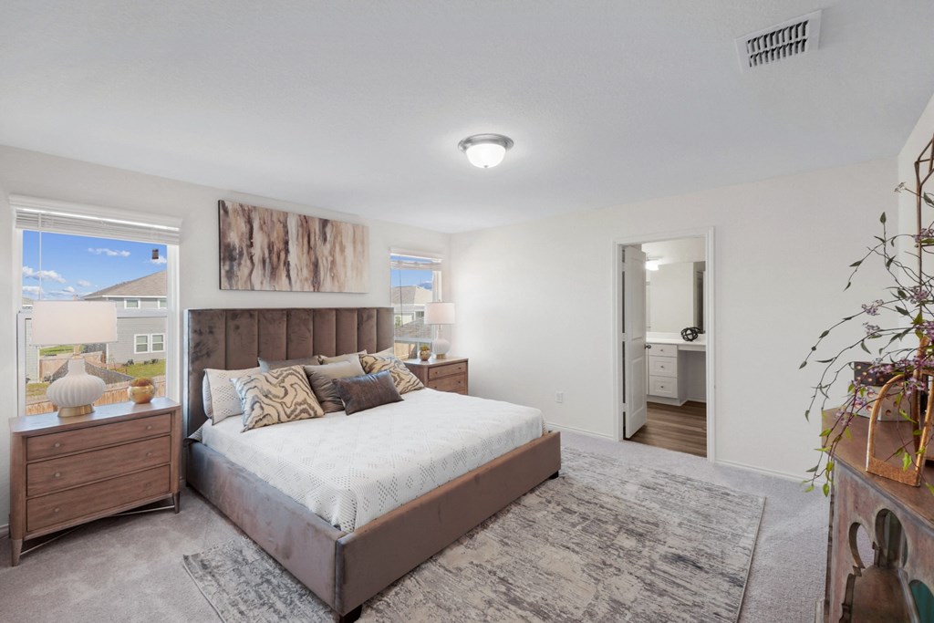 a bedroom with a bed and two night stands at Beacon at Meridian, San Antonio Texas