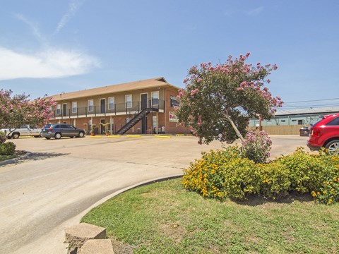 A building with a parking lot in front of it.