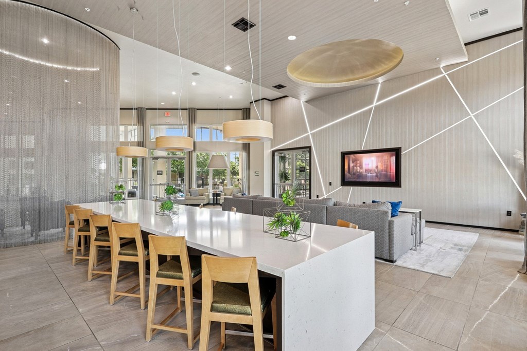 Clubhouse kitchen with island and a couch at GreenVue apartments in Richardson, TX