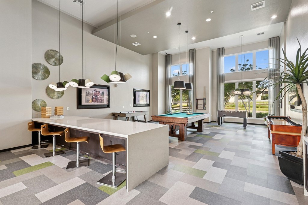 Game room with pool table, air hockey, and more at GreenVue apartments in Richardson, TX
