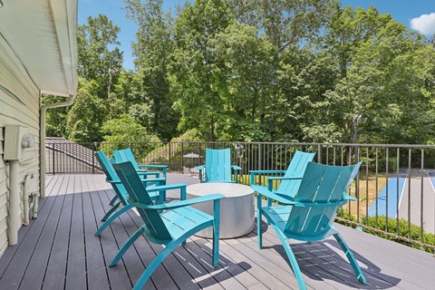 A set of six chairs and a table are on a deck at Gwinnett Square Apartments in Duluth, GA