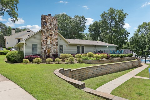 The exterior of the leasing office with lush grass and landscaping at Gwinnett Square Apartments in Duluth, GA