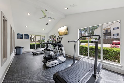 A fitness center with treadmills and ellipticals at Gwinnett Square Apartments in Duluth, GA