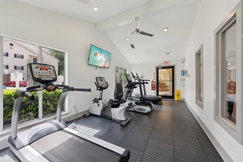 A fitness center with treadmills and ellipticals at Gwinnett Square Apartments in Duluth, GA