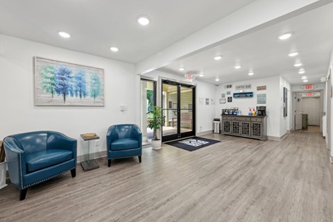 A leasing office with a coffee bar and chairs at Gwinnett Square Apartments in Duluth, GA