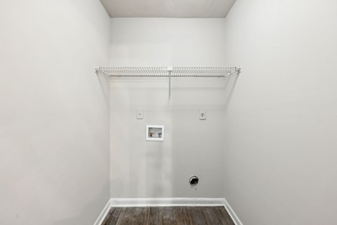 A closet with a shelf and clothes rod at Gwinnett Square Apartments in Duluth, GA