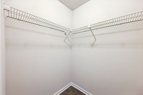 A closets with shelves and clothes rods at Gwinnett Square Apartments in Duluth, GA