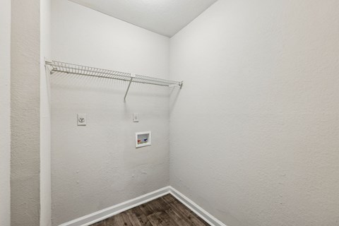 A closet with a metal shelf and clothes rod at Gwinnett Square Apartments in Duluth, GA