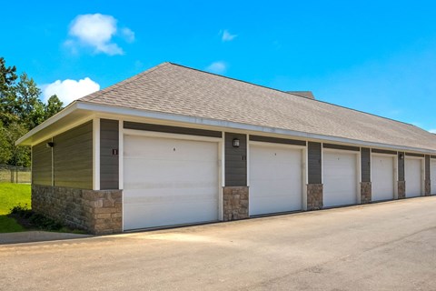 a row of garages with a blue sky in the background