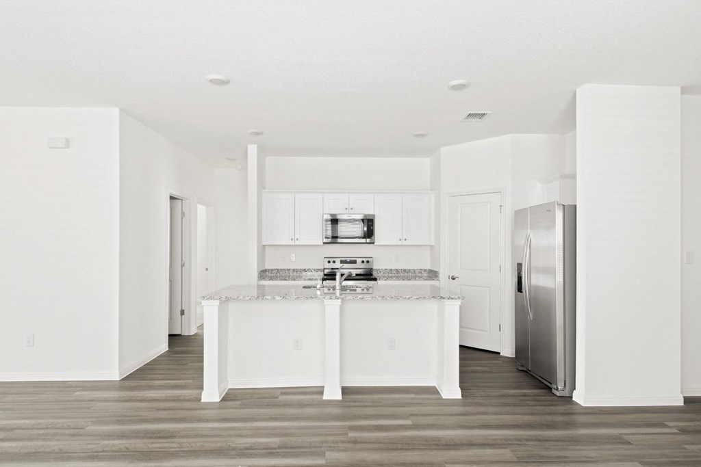 a kitchen with white cabinets and stainless steel appliances at Beacon at Meridian, Texas