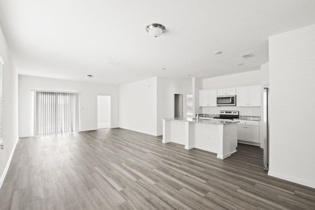 living room with open kitchen and a big window