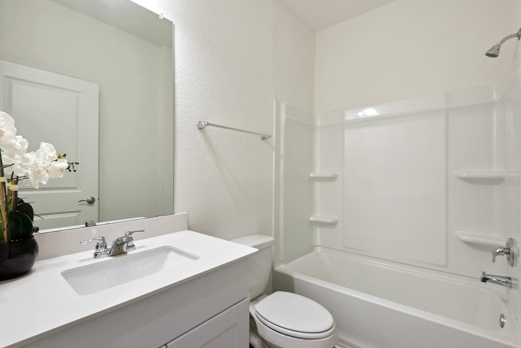 a bathroom with a sink toilet and bathtub