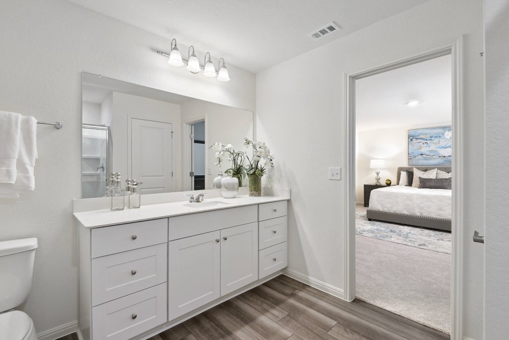 a bathroom with a large mirror and a toilet