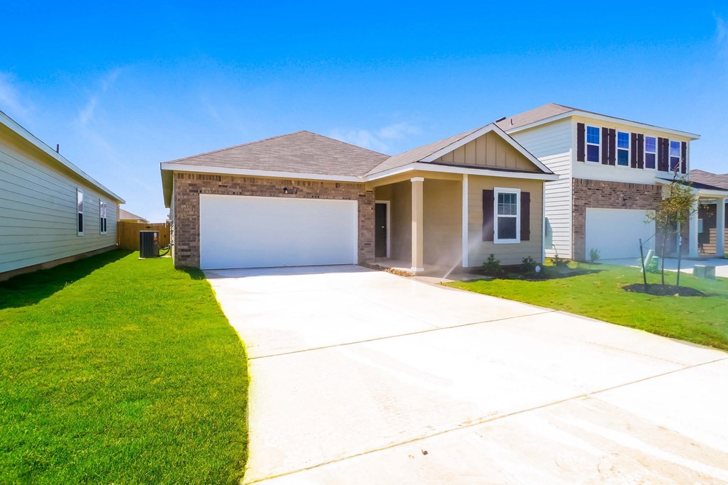a house with a long driveway and a lawn at Beacon at Meridian, San Antonio, TX 78245