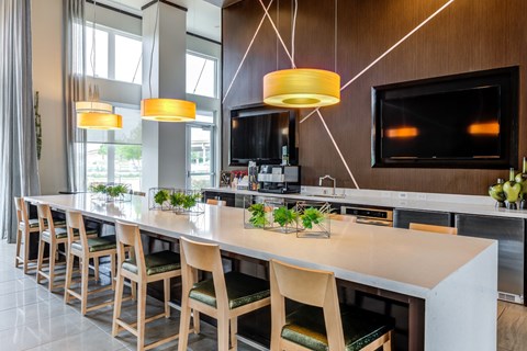 the kitchen and dining area of a hotel with a long table and chairs