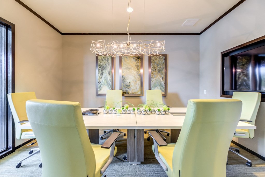 a dining room with a table and chairs and a chandelier