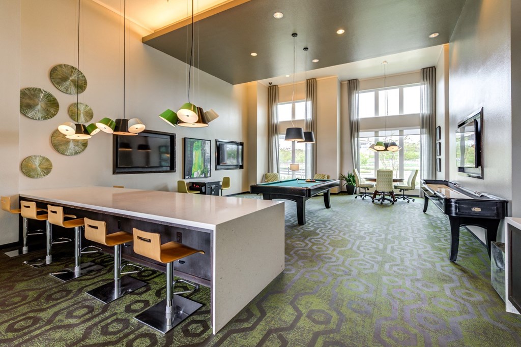 a living room with a dining room table and a piano