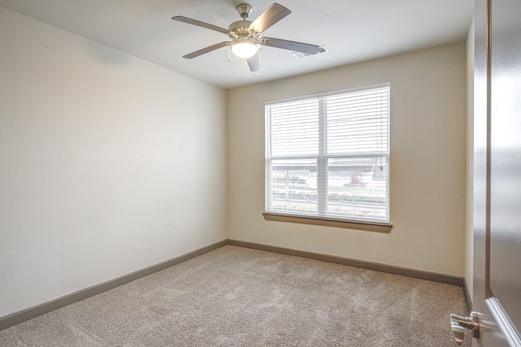 a room with a row of triangles on the wall and a window