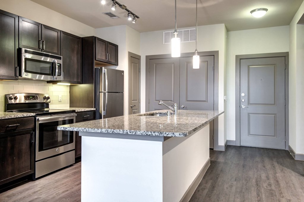 a kitchen with stainless steel appliances and a granite counter top