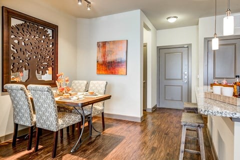 a dining room with a wooden table and chairs