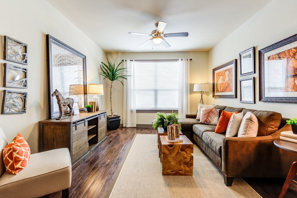 a living room with a couch and a ceiling fan