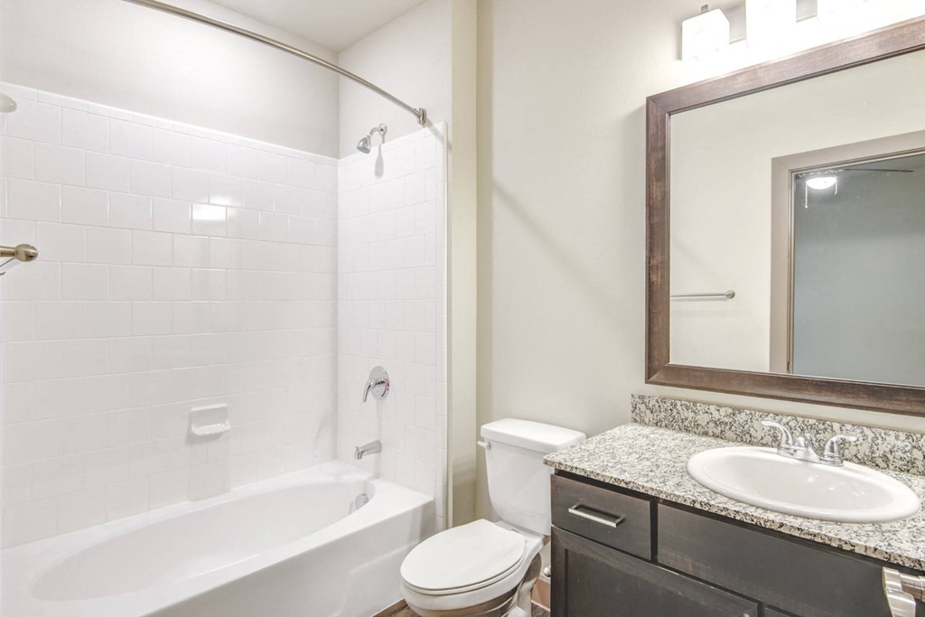a bathroom with a sink toilet and a bath tub