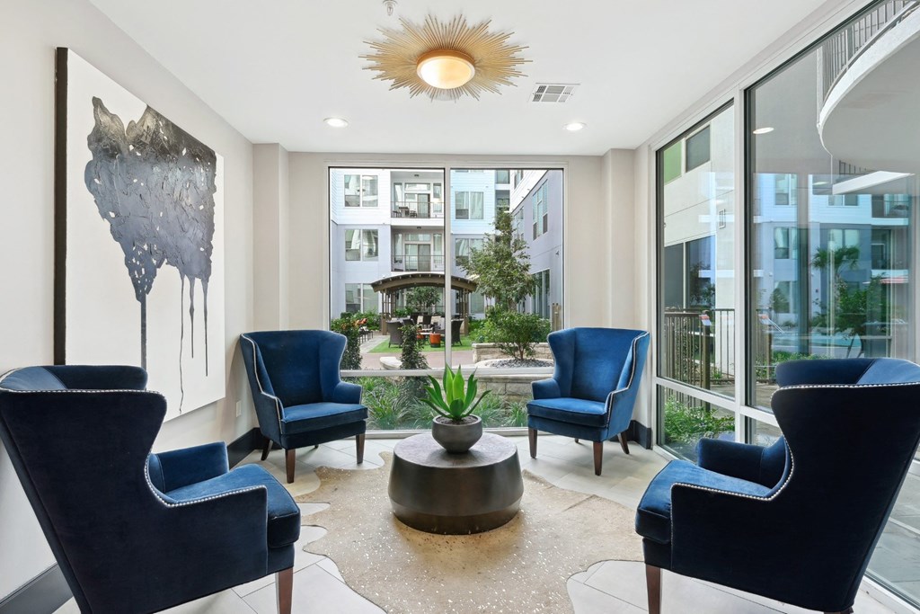 Indoor seating by large windows at Harlow River Oaks in Houston, TX