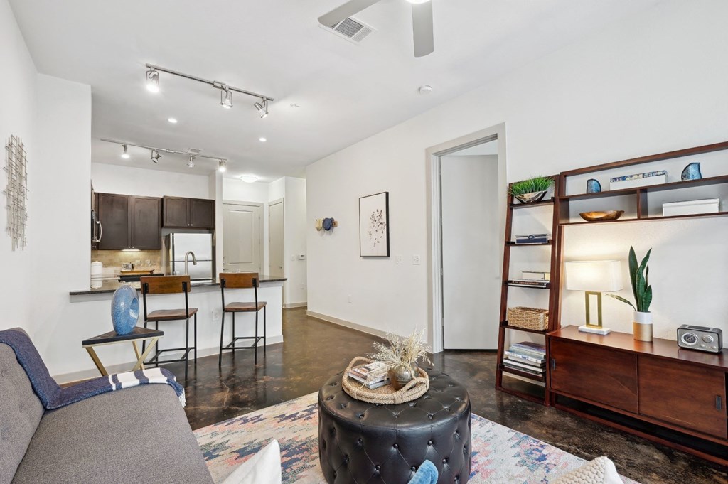 Model living room with a couch and a coffee table at Harlow River Oaks in Houston, TX