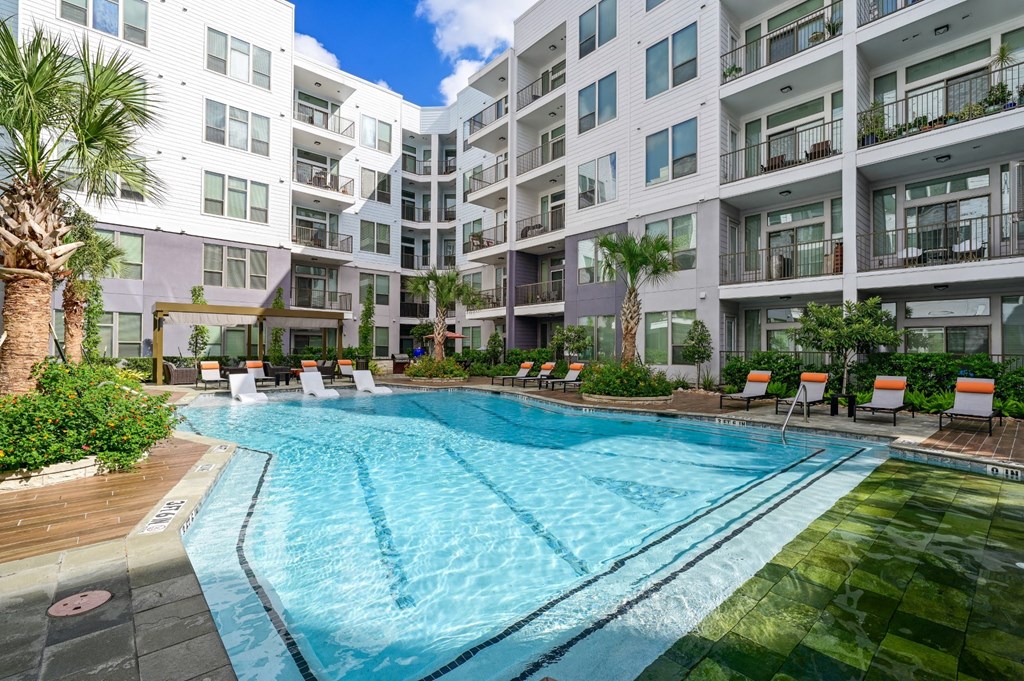 Swimming pool with lounge seating at Harlow River Oaks in Houston, TX