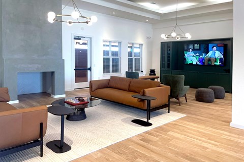 A living room with a television and a fireplace.