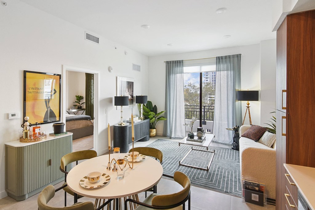A modern dining room with a round table and chairs at Hollywood Heights on the Boulevard Luxury Apartments in Hollywood, FL