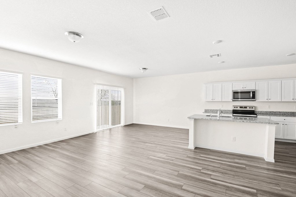 the living room with wood floor and big windows