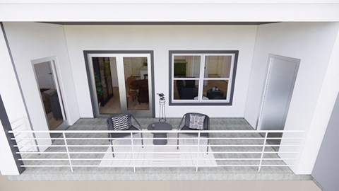 A balcony with a table and chairs overlooking a room.
