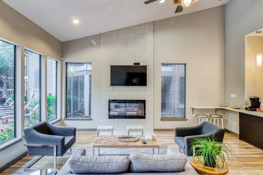 Clubhouse space with fireplace and a couch at Hillside Creek Apartments in Austin, TX