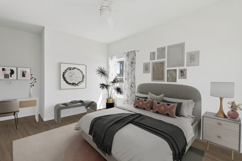 A bedroom with a large bed and a bench.