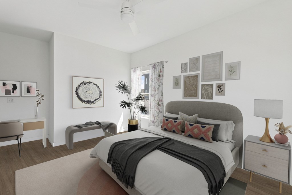 A bedroom with a large bed and a bench.