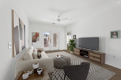 A living room with a couch, chair, and television.