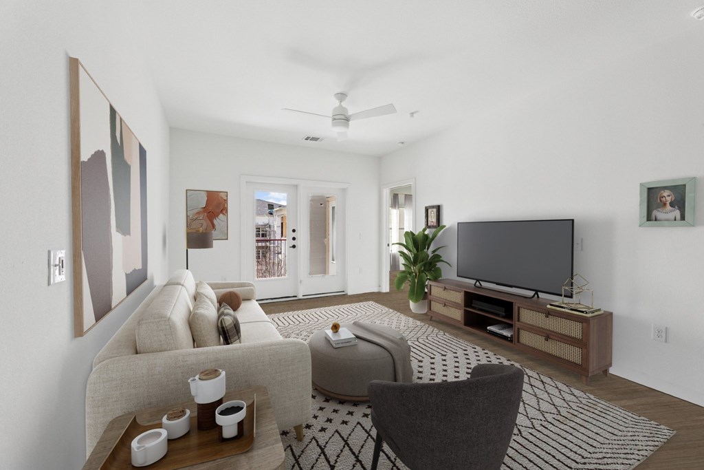 A living room with a couch, chair, and television.