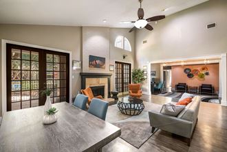 a living room filled with furniture and a ceiling fan