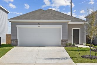 a house with a white garage door at Beacon at Hymeadow, Maxwell, Texas