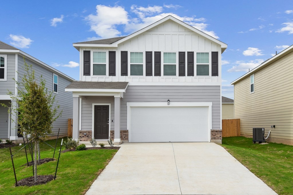 a house with a white door and gray siding at Beacon at Hymeadow, Maxwell, Texas