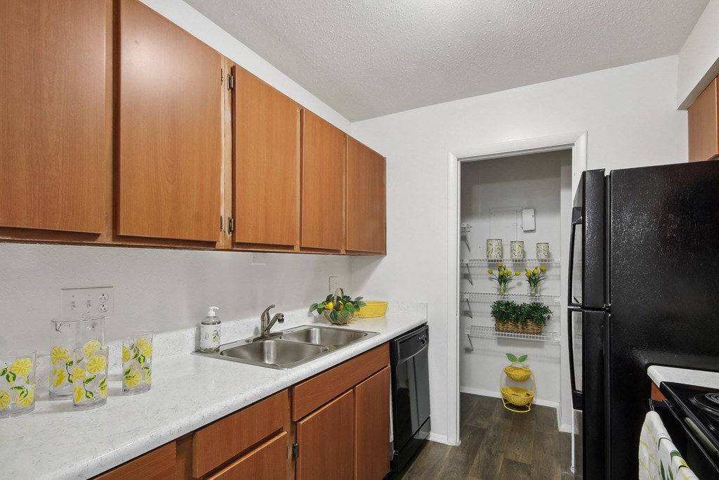kitchen with wooden cabinets at Johnston Creek Crossing in Charlotte, NC